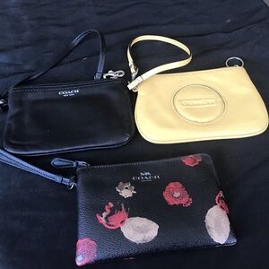 Three Coach wristlets.